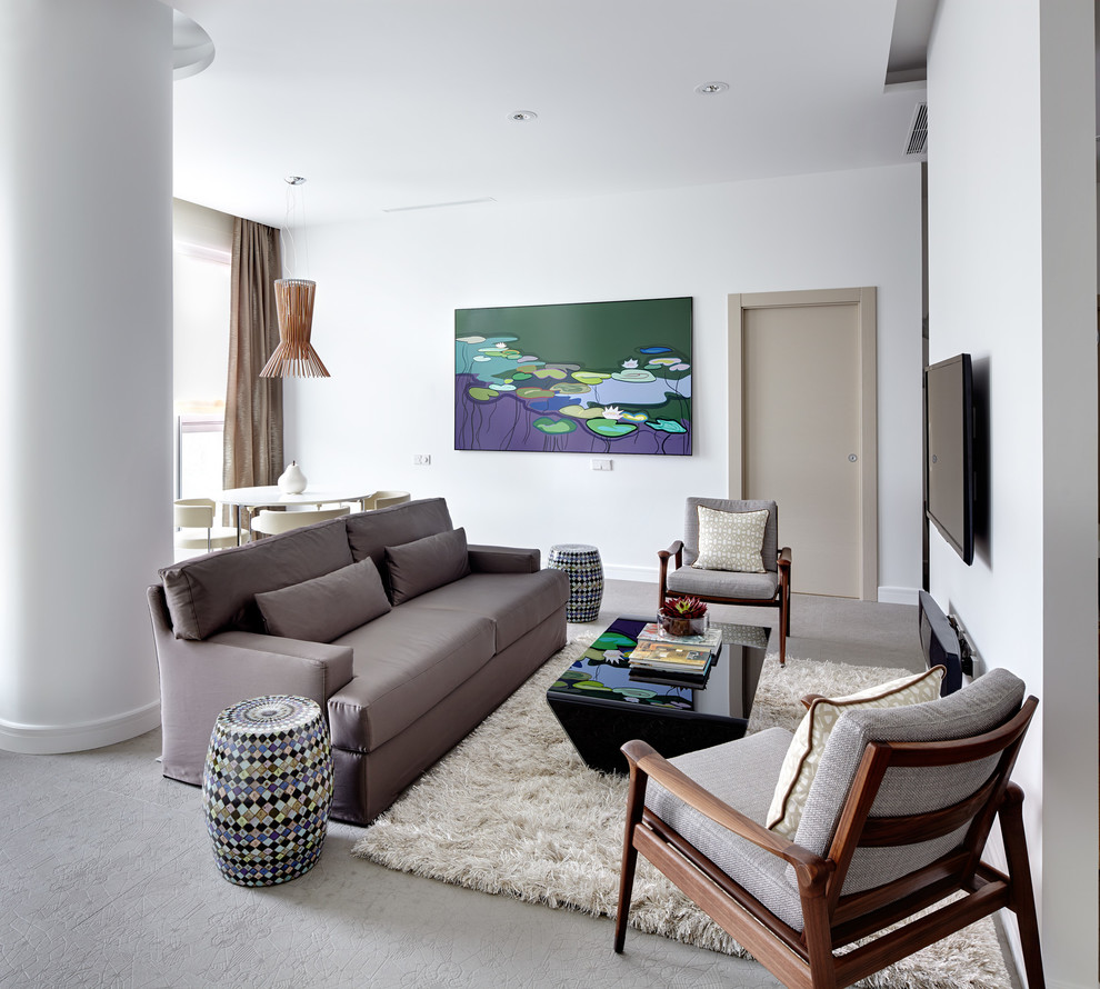 Photo of a contemporary living room with white walls and grey floor.