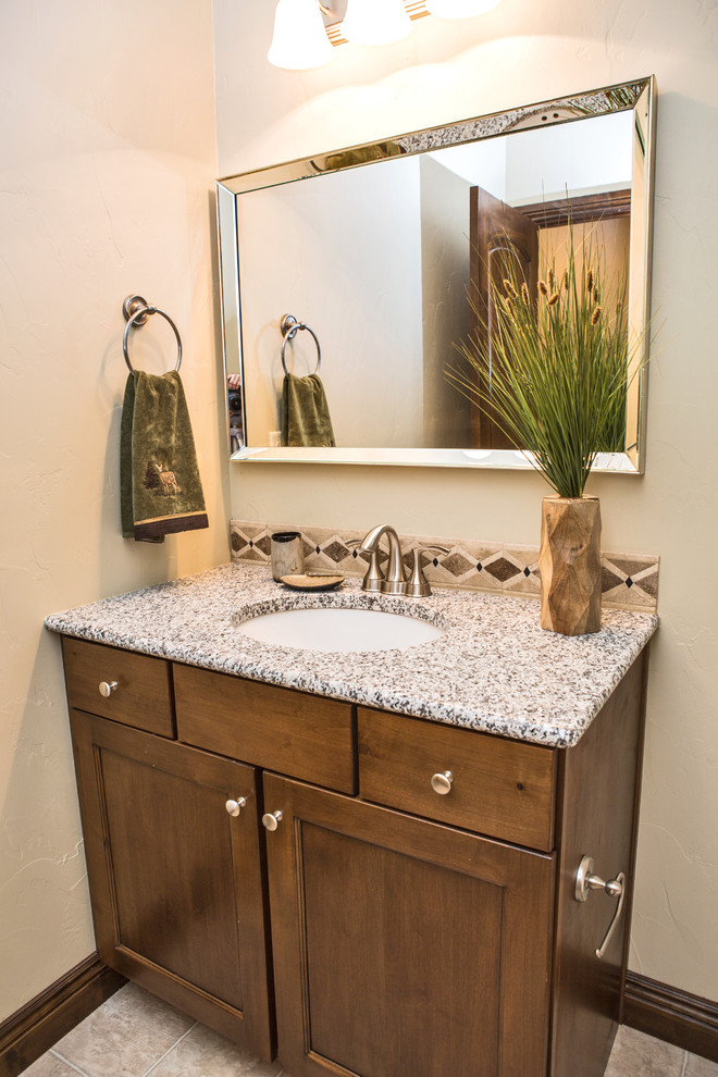 Design ideas for a mid-sized transitional powder room in Denver with shaker cabinets, medium wood cabinets, beige walls, an undermount sink and granite benchtops.