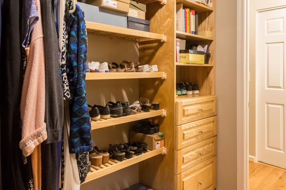 Design ideas for a large contemporary women's walk-in wardrobe in Other with beaded inset cabinets, dark wood cabinets and limestone floors.