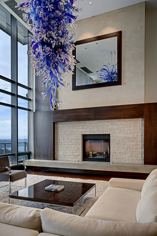 Photo of a contemporary living room in Seattle with a stone fireplace surround.