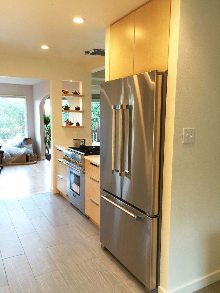 Inspiration for a large modern galley porcelain tile open concept kitchen remodel in San Francisco with a drop-in sink, flat-panel cabinets, light wood cabinets, quartz countertops, multicolored backsplash, mosaic tile backsplash, stainless steel appliances and an island