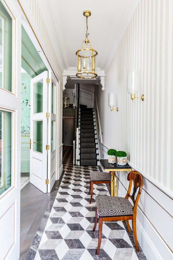 This is an example of a transitional hallway in London with multi-coloured walls and multi-coloured floor.