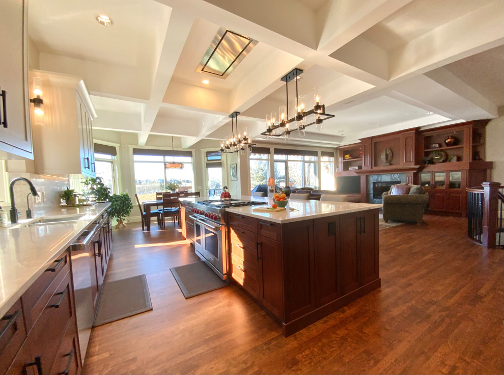 Eat-in kitchen - large transitional single-wall dark wood floor, brown floor and coffered ceiling eat-in kitchen idea in Calgary with an undermount sink, shaker cabinets, quartzite countertops, white backsplash, stainless steel appliances, an island and white countertops