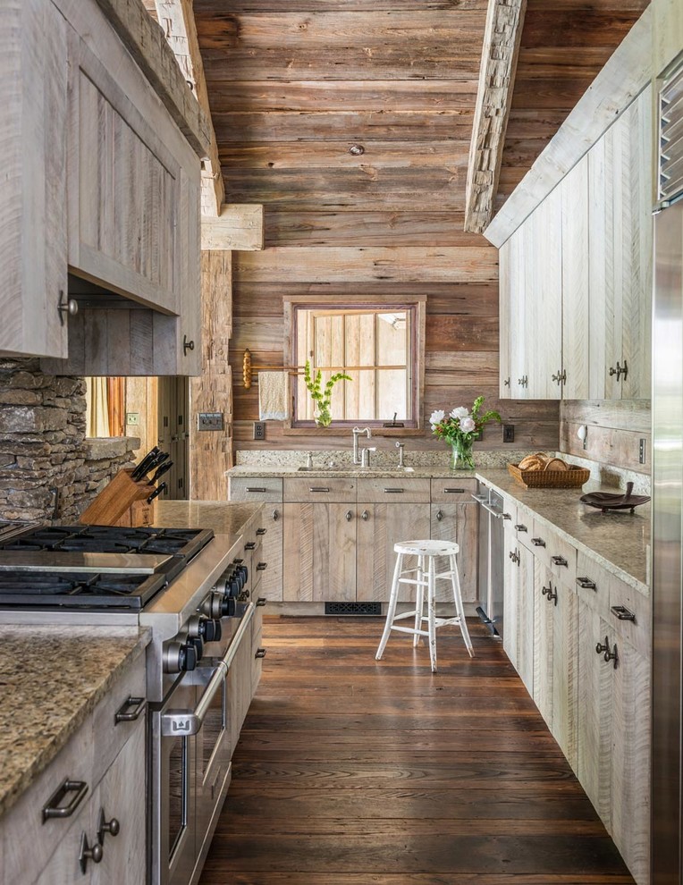 Country l-shaped kitchen in Other with an undermount sink, flat-panel cabinets, light wood cabinets, stainless steel appliances, dark hardwood floors and brown floor.