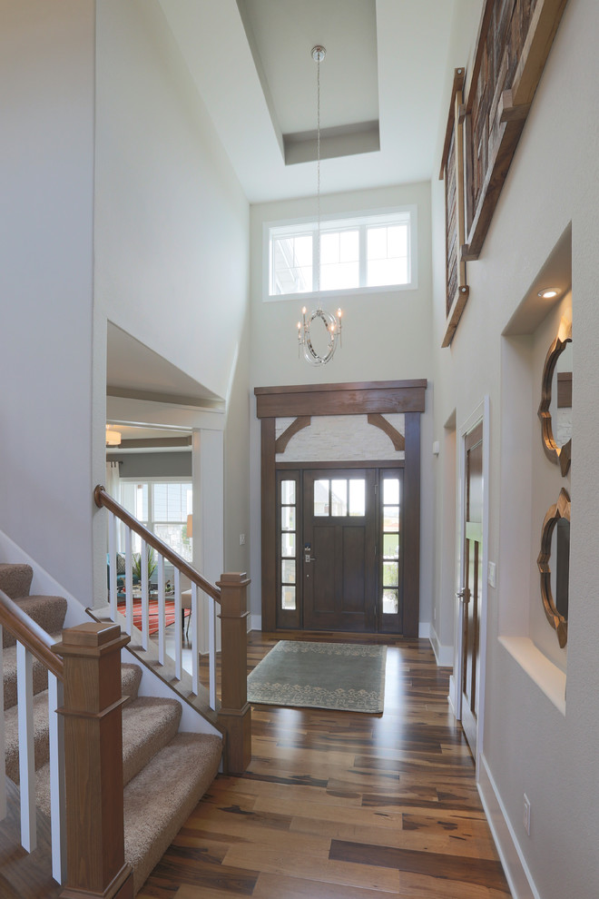 Mid-sized arts and crafts foyer in Milwaukee with grey walls, porcelain floors, a single front door and a dark wood front door.