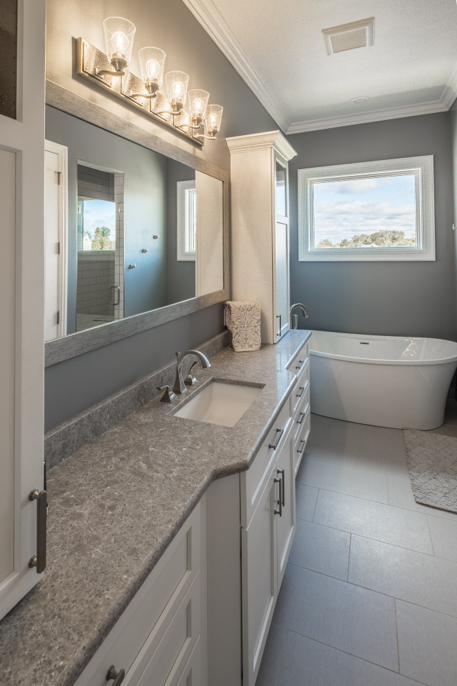 Mid-sized country master bathroom in Detroit with recessed-panel cabinets, white cabinets, a freestanding tub, grey walls, porcelain floors, an undermount sink, grey floor, grey benchtops, a single vanity and a built-in vanity.