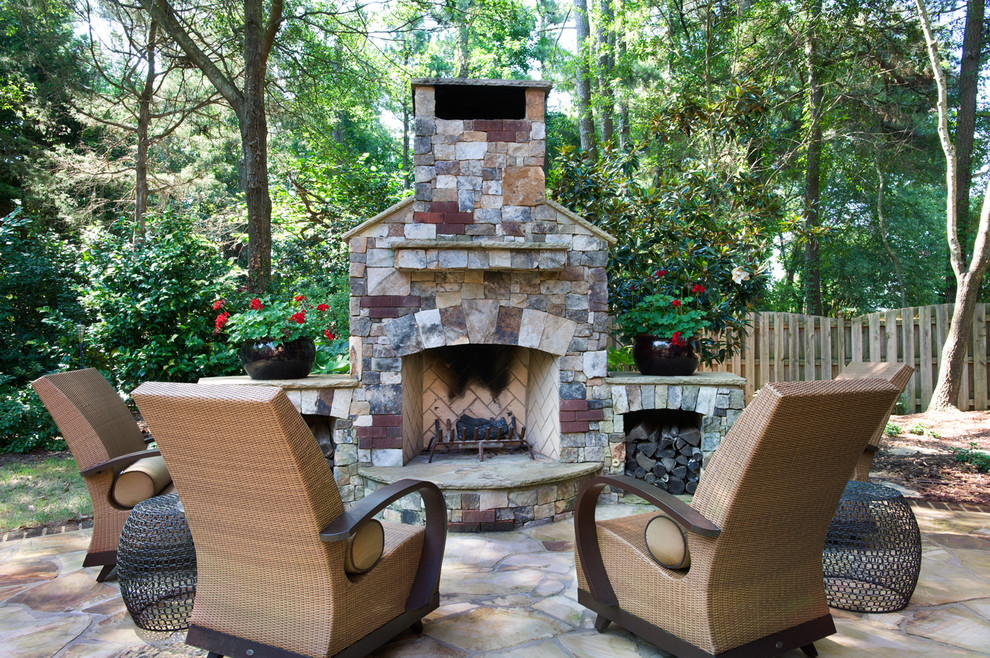 Inspiration for a traditional backyard patio in Other with a fire feature, natural stone pavers and no cover.