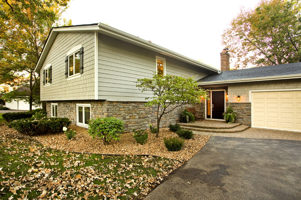 Design ideas for a traditional split-level grey exterior in Minneapolis with mixed siding and a gable roof.