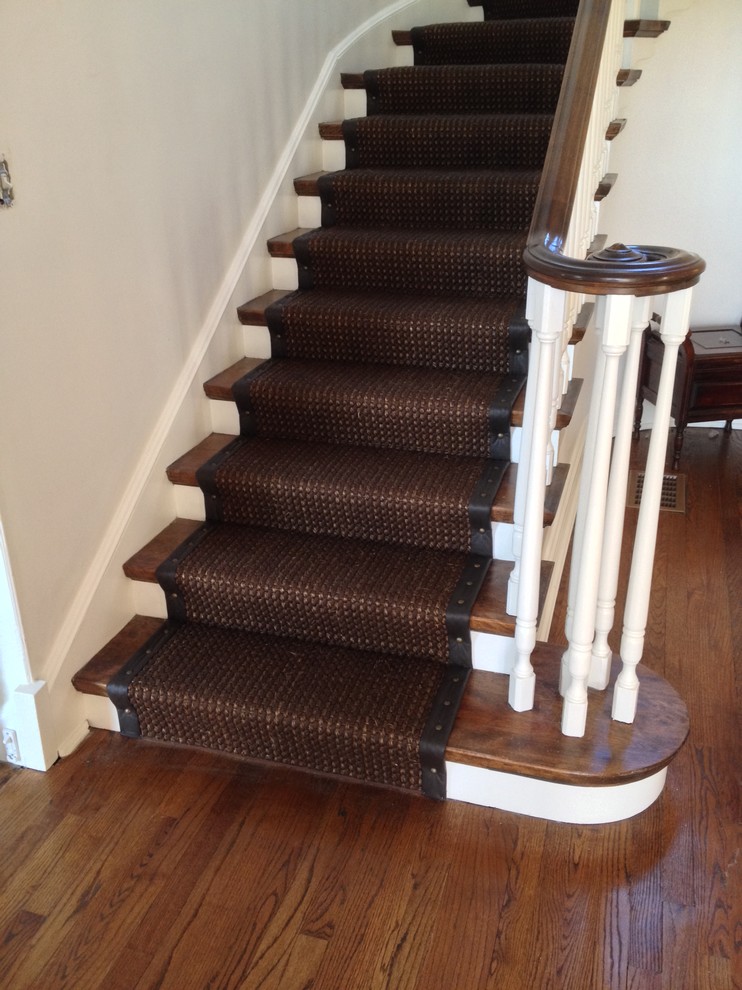 Photo of a medium sized traditional wood curved wood railing staircase in Chicago with painted wood risers.