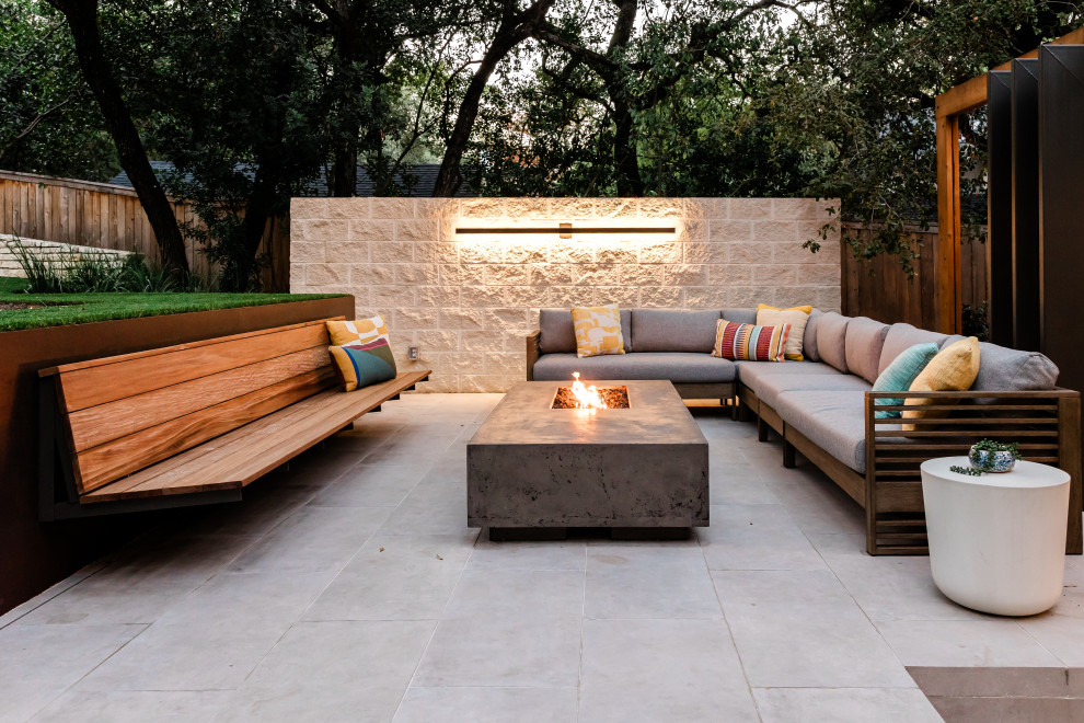 Patio - large backyard tile patio idea in Austin with a fire pit