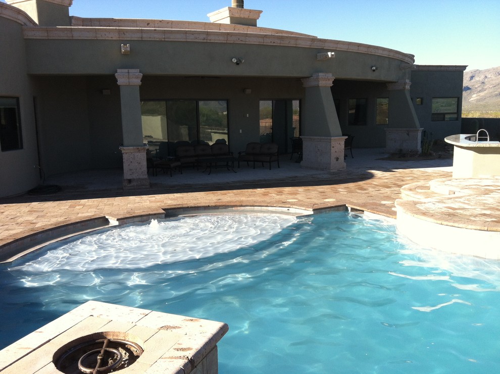 Small mediterranean stucco exterior in Phoenix with a flat roof.