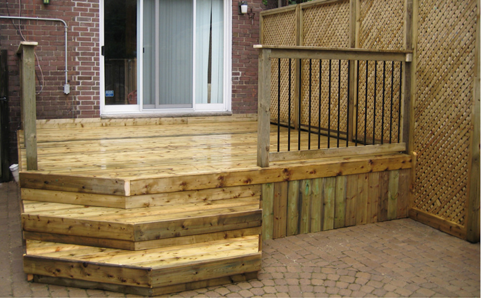 This is an example of a small traditional backyard deck in Wichita with no cover.