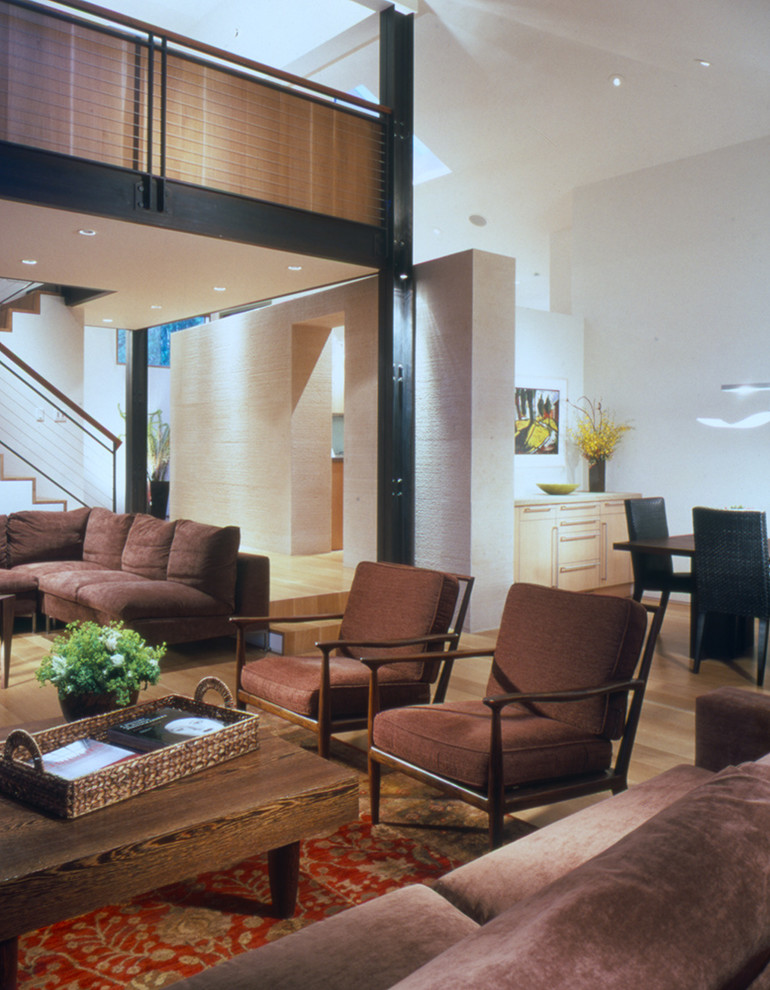 Photo of a large contemporary loft-style living room in Denver with brown floor.