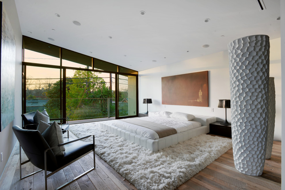 Inspiration for a large contemporary master medium tone wood floor and brown floor bedroom remodel in Los Angeles with white walls and no fireplace