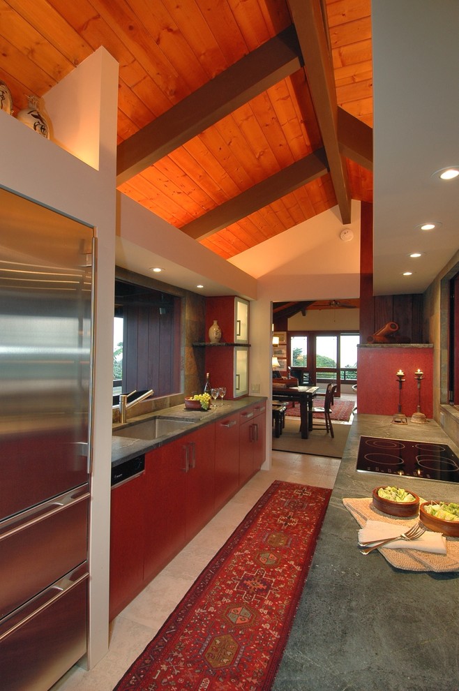 Photo of a tropical kitchen in Hawaii with flat-panel cabinets, stainless steel appliances and green benchtop.