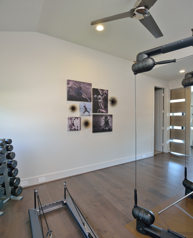 Photo of a mid-sized modern home weight room in Houston with grey walls.