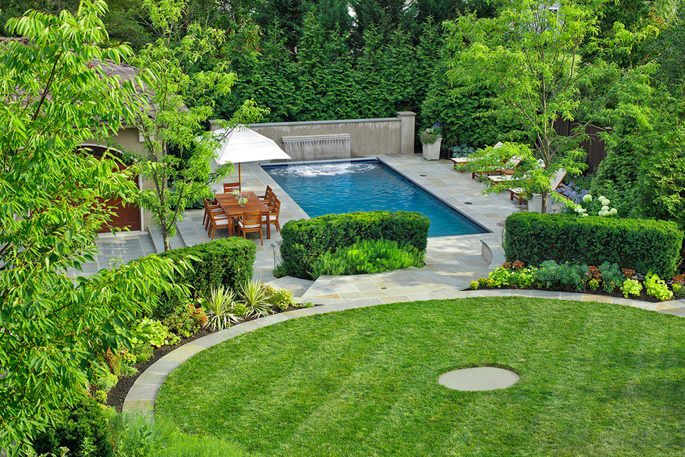 Inspiration for a traditional pool in DC Metro with a water feature.