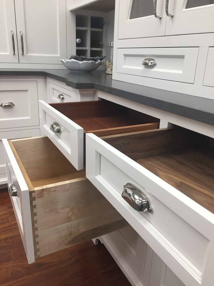Inspiration for a transitional kitchen remodel in Boston with shaker cabinets, quartz countertops, an island and white cabinets