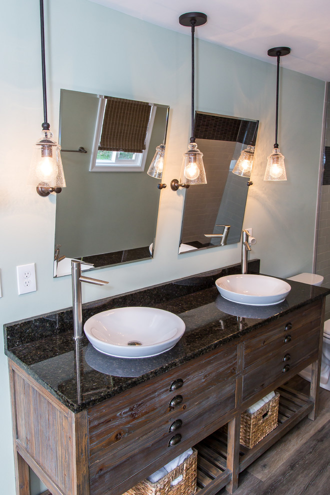 This is an example of a mid-sized transitional 3/4 bathroom in Other with furniture-like cabinets, distressed cabinets, a shower/bathtub combo, white tile, ceramic tile, grey walls, vinyl floors, a vessel sink, brown floor, an open shower and granite benchtops.