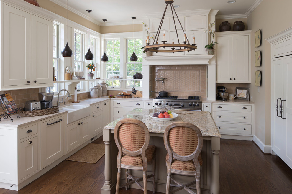 Mid-sized country u-shaped eat-in kitchen in Indianapolis with a farmhouse sink, shaker cabinets, white cabinets, beige splashback, subway tile splashback, panelled appliances, marble benchtops, with island and white benchtop.