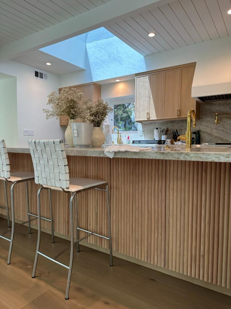 This is an example of a kitchen in Los Angeles with an undermount sink, raised-panel cabinets, medium wood cabinets, marble benchtops, multi-coloured splashback, marble splashback, coloured appliances, painted wood floors, beige floor and multi-coloured benchtop.