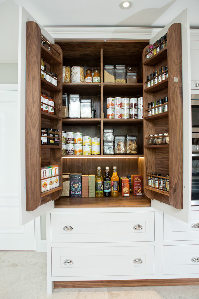 This is an example of a traditional kitchen pantry in Berkshire with shaker cabinets, white cabinets and concrete floors.