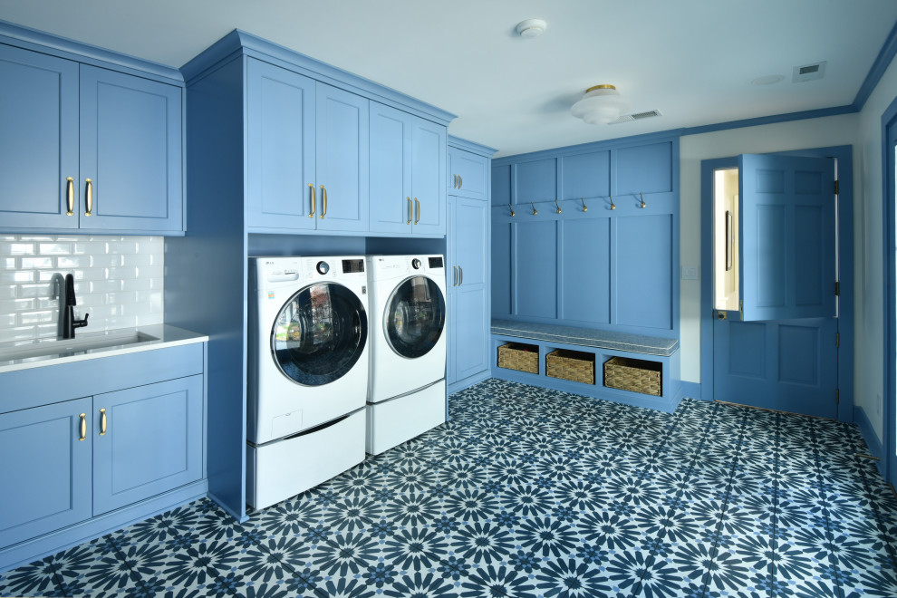 Design ideas for an expansive transitional u-shaped utility room in Other with an undermount sink, flat-panel cabinets, blue cabinets, quartz benchtops, white splashback, subway tile splashback, white walls, concrete floors, a side-by-side washer and dryer, blue floor and white benchtop.