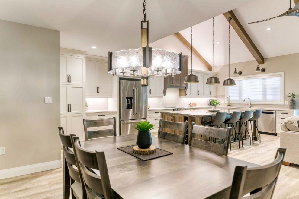 Inspiration for a large transitional eat-in kitchen remodel with an undermount sink, shaker cabinets, quartz countertops, porcelain backsplash, stainless steel appliances and an island