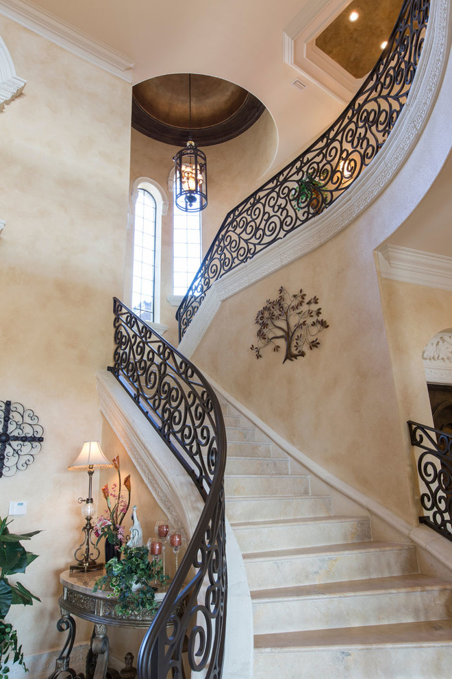 This is an example of an expansive mediterranean curved staircase in Orlando.