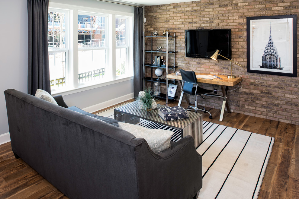 Transitional family room in DC Metro with dark hardwood floors, a wall-mounted tv and brown floor.