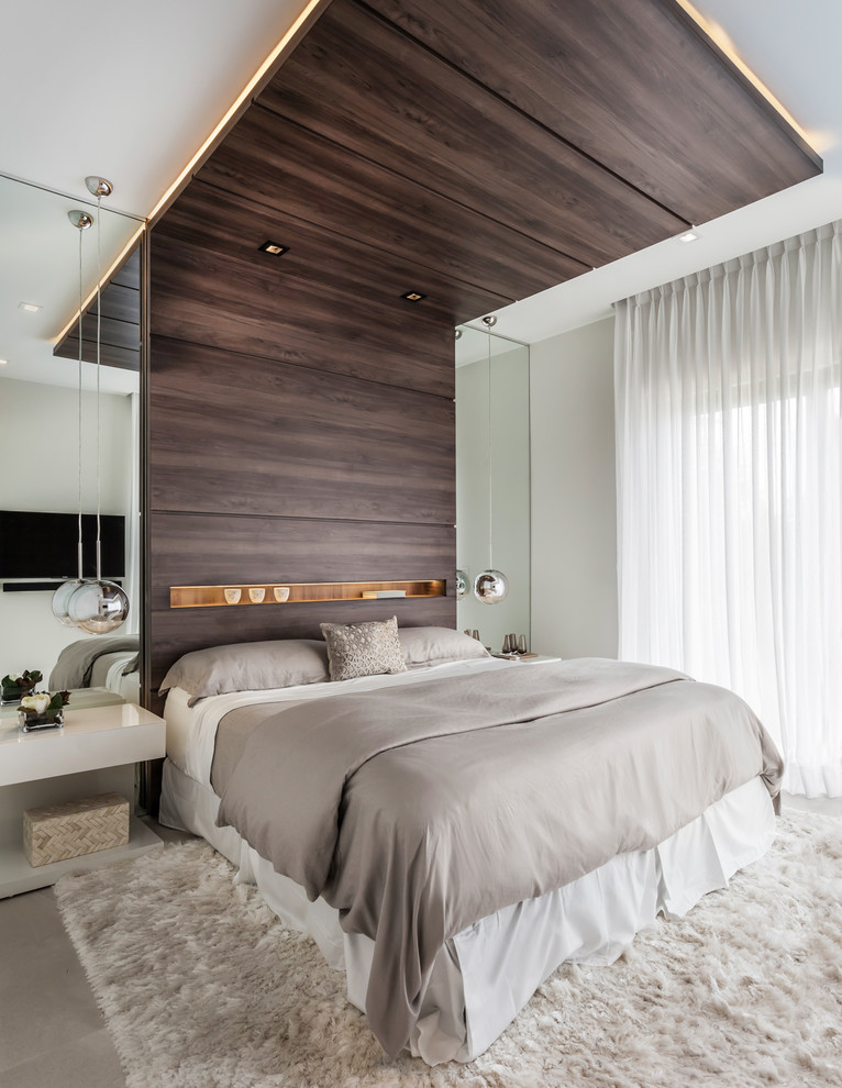 Photo of a large contemporary guest bedroom in Miami with white walls, ceramic floors, no fireplace and beige floor.