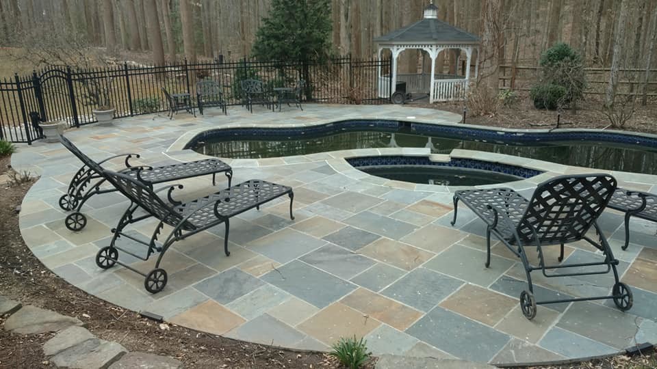 Example of a huge transitional backyard stone and kidney-shaped natural pool design