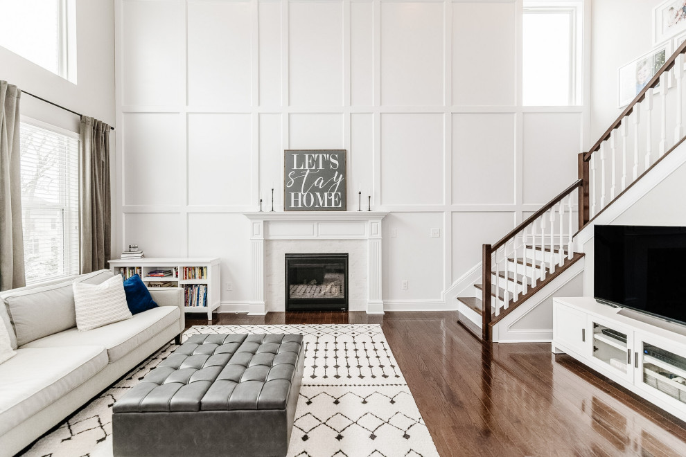 Living room - large transitional open concept dark wood floor, coffered ceiling and wainscoting living room idea in Cincinnati with gray walls, a standard fireplace, a stone fireplace and a tv stand