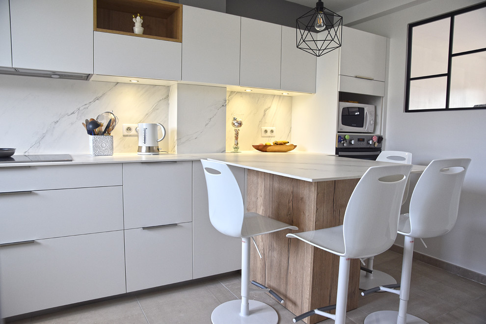 Inspiration for a mid-sized modern u-shaped separate kitchen in Lyon with an integrated sink, beaded inset cabinets, white cabinets, tile benchtops, white splashback, ceramic splashback, stainless steel appliances, ceramic floors and grey floor.