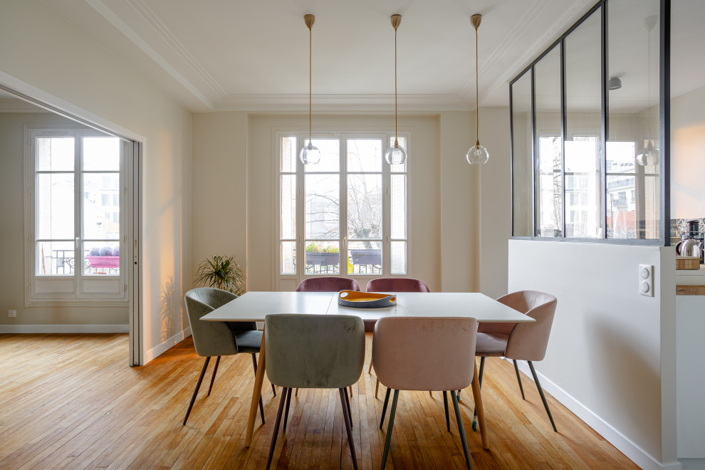 Inspiration for a contemporary light wood floor dining room remodel in Paris with white walls