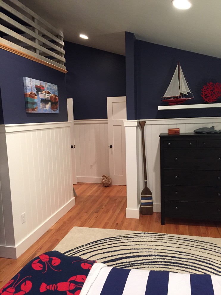 Photo of a traditional kids' bedroom for kids 4-10 years old and boys in Providence with blue walls and medium hardwood floors.