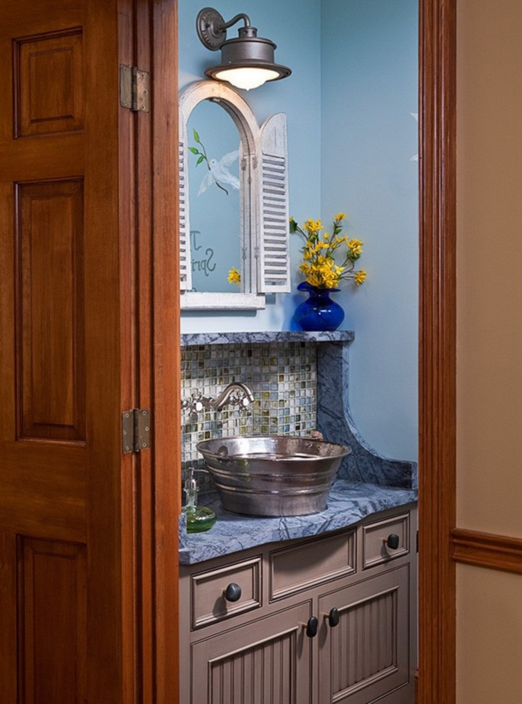 Country bathroom in Other with a vessel sink, beaded inset cabinets, soapstone benchtops, multi-coloured tile, mosaic tile and blue walls.