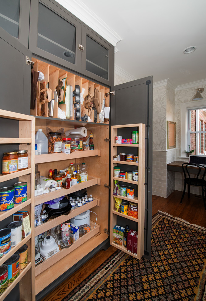Photo of a transitional kitchen pantry in Chicago with grey cabinets.