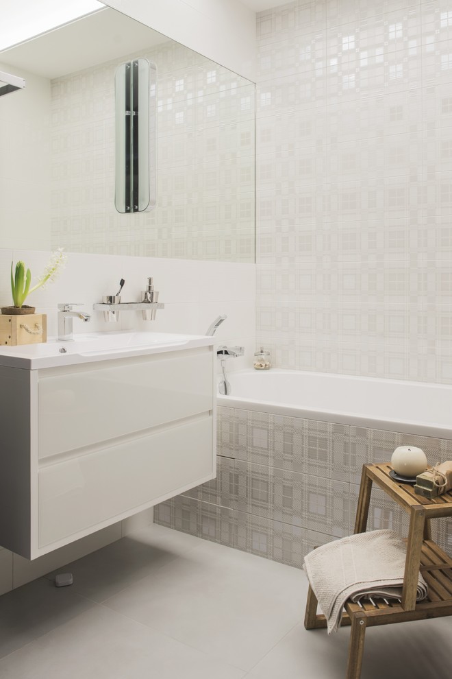Design ideas for a small contemporary master bathroom in Moscow with flat-panel cabinets, white cabinets, white tile, ceramic tile, porcelain floors, solid surface benchtops, an alcove tub, an integrated sink, a shower/bathtub combo, grey floor, a single vanity, a floating vanity and recessed.