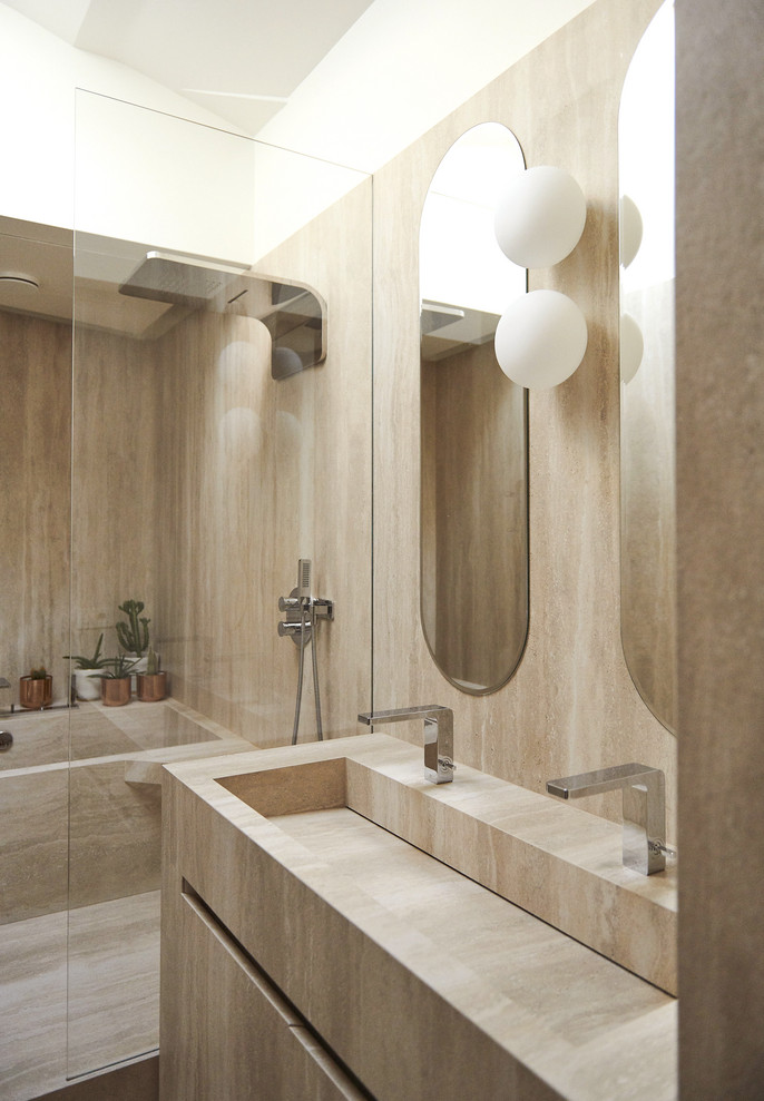 Mid-sized contemporary master wet room bathroom in Other with beige cabinets, beige tile, limestone, beige walls, limestone floors, limestone benchtops, beige floor, beige benchtops, flat-panel cabinets, an alcove tub and a trough sink.