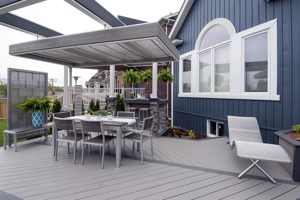 Inspiration for a mid-sized industrial backyard deck in Toronto with a fire feature and a pergola.