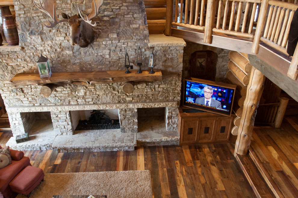 Inspiration for an expansive country open concept family room in Denver with multi-coloured walls, a standard fireplace, a stone fireplace surround and a concealed tv.