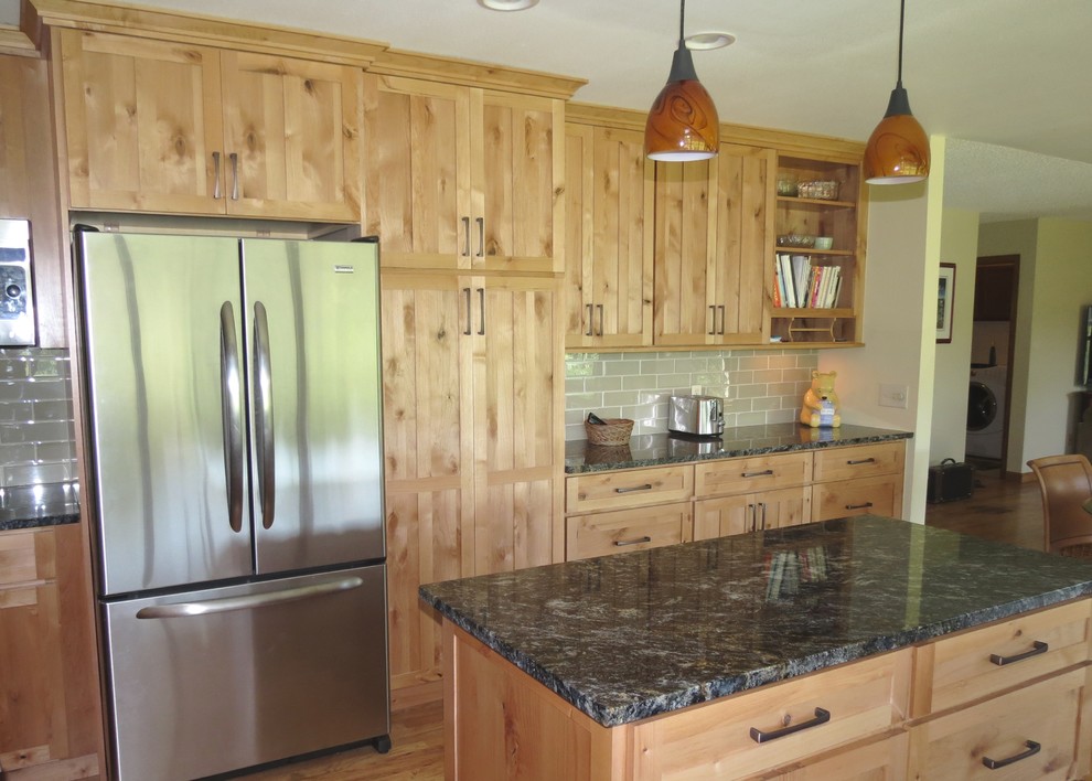 Inspiration for a mid-sized transitional u-shaped light wood floor open concept kitchen remodel in Denver with an undermount sink, recessed-panel cabinets, light wood cabinets, granite countertops, glass tile backsplash, stainless steel appliances and an island