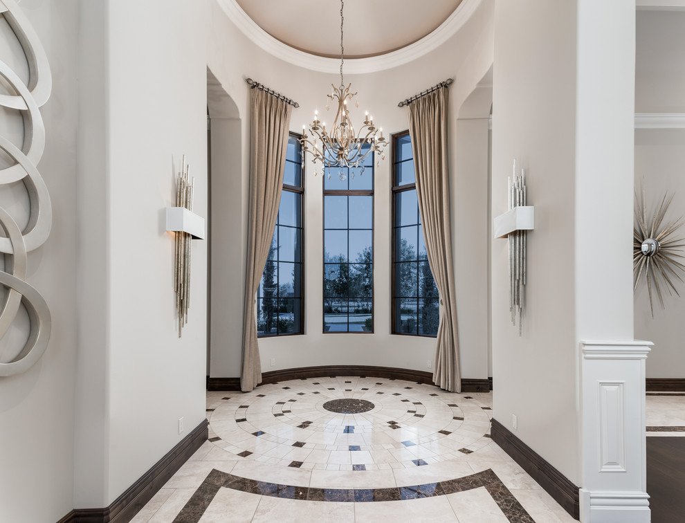 Expansive mediterranean foyer in Phoenix with white walls, marble floors, a double front door, a brown front door, multi-coloured floor, coffered and panelled walls.