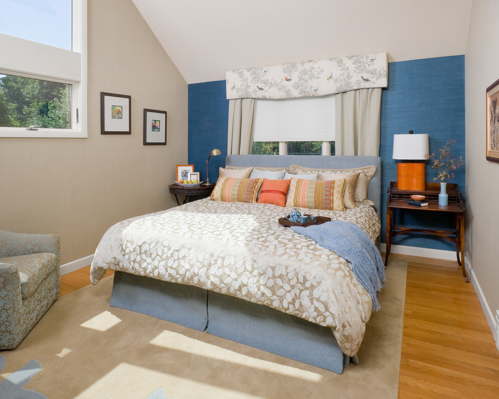 This is an example of a traditional bedroom in Boston with multi-coloured walls, medium hardwood floors and yellow floor.
