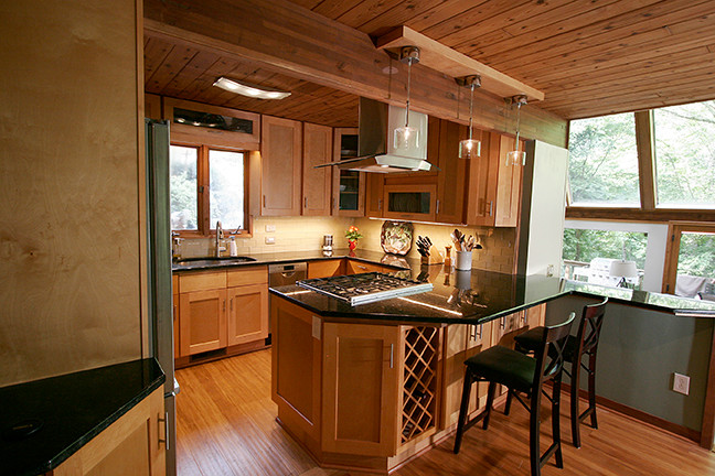 Inspiration for a small transitional l-shaped porcelain tile eat-in kitchen remodel with shaker cabinets, light wood cabinets, granite countertops, beige backsplash, glass tile backsplash, stainless steel appliances and a peninsula