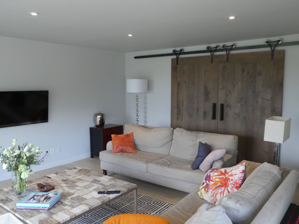 Photo of a medium sized rustic living room in Wiltshire with white walls, laminate floors and beige floors.