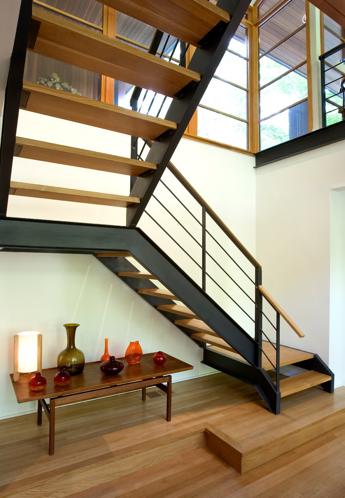Mid-sized modern wood floating staircase in Other with mixed railing and open risers.
