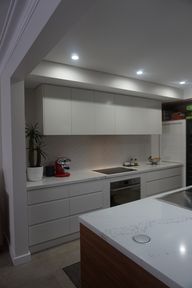 Inspiration for a mid-sized contemporary l-shaped eat-in kitchen in Sydney with a drop-in sink, open cabinets, white cabinets, quartz benchtops, white splashback, porcelain splashback, stainless steel appliances, ceramic floors and with island.
