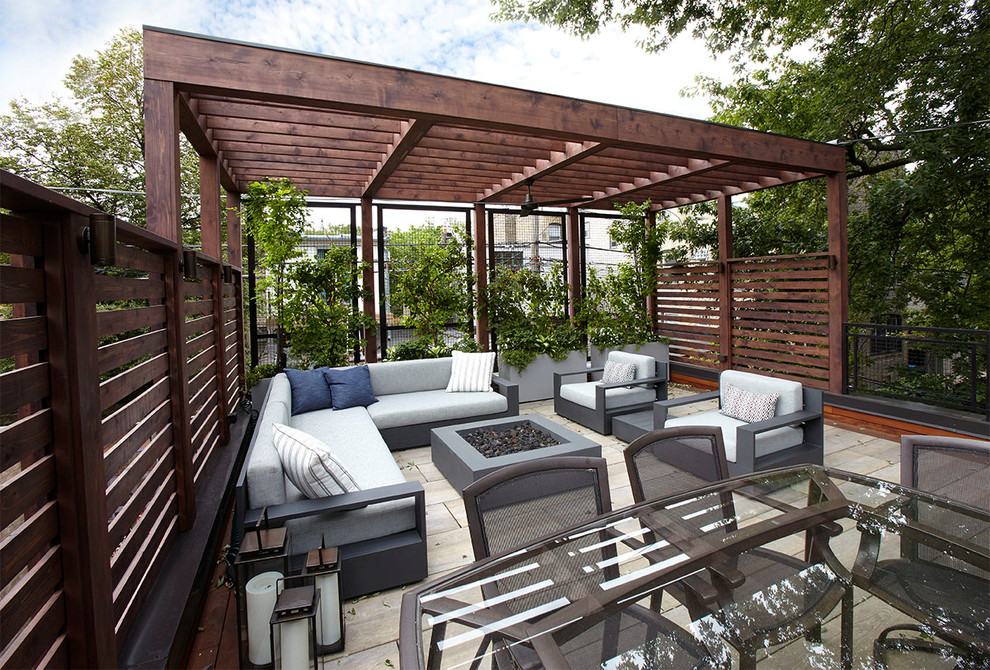 Design ideas for a mid-sized transitional rooftop deck in Chicago with a vertical garden and a pergola.